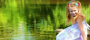 cute-baby-girl-sitting-near-pond-beautiful-smile-cool-facebook-timeline-covers